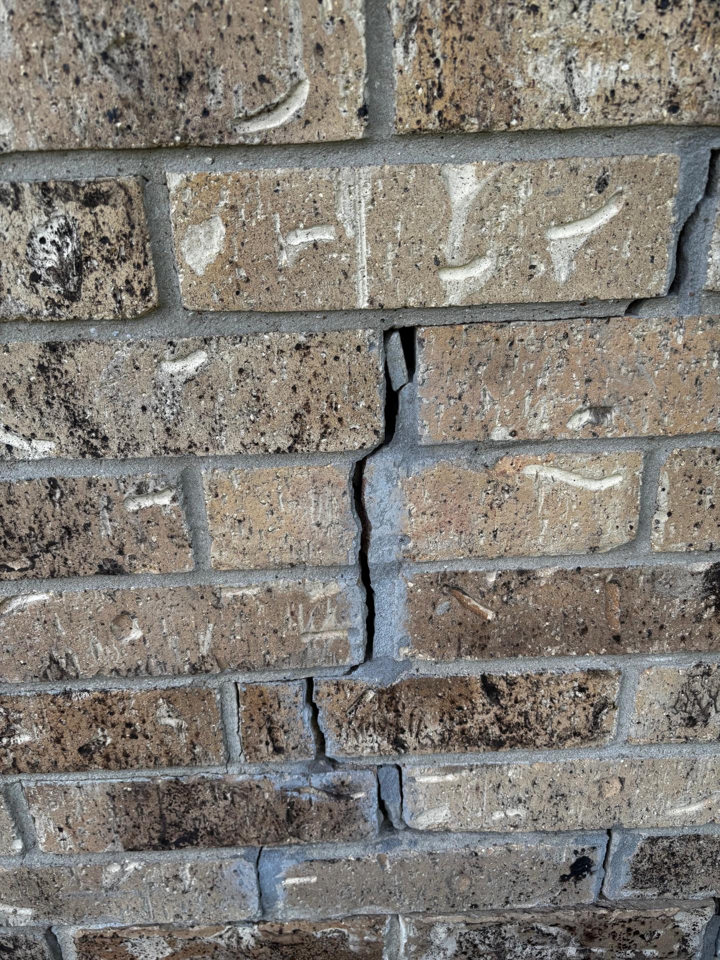 A settling crack in a brick exterior wall that appeared on a home about a year after closing.